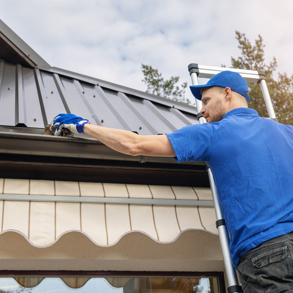 man cleaning gutter